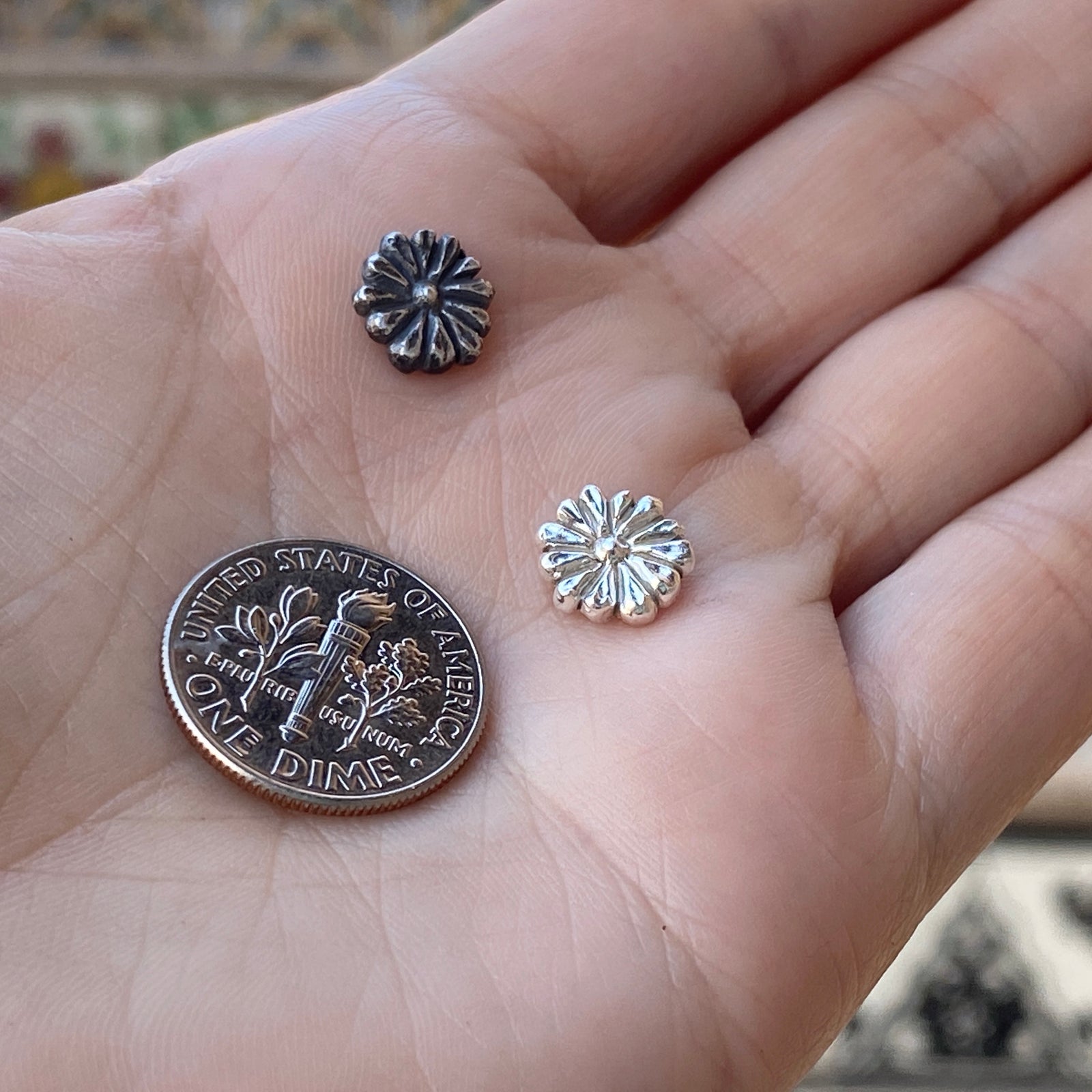 cast silver flower with dime for size reference