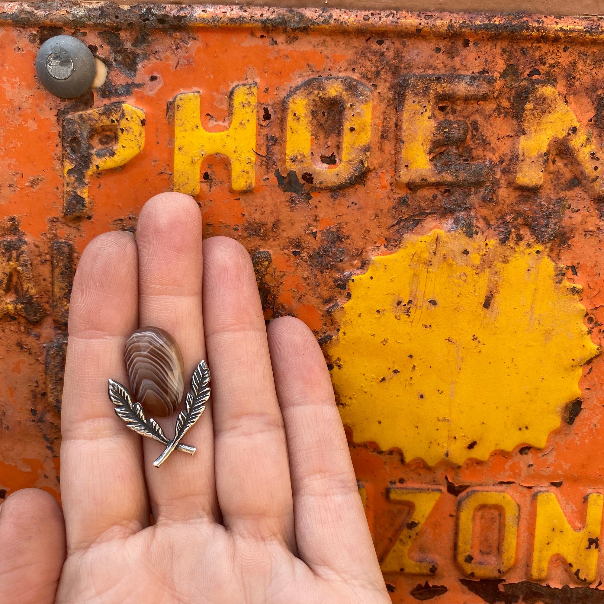 silver feather casting framing a Botswana agate cabochon